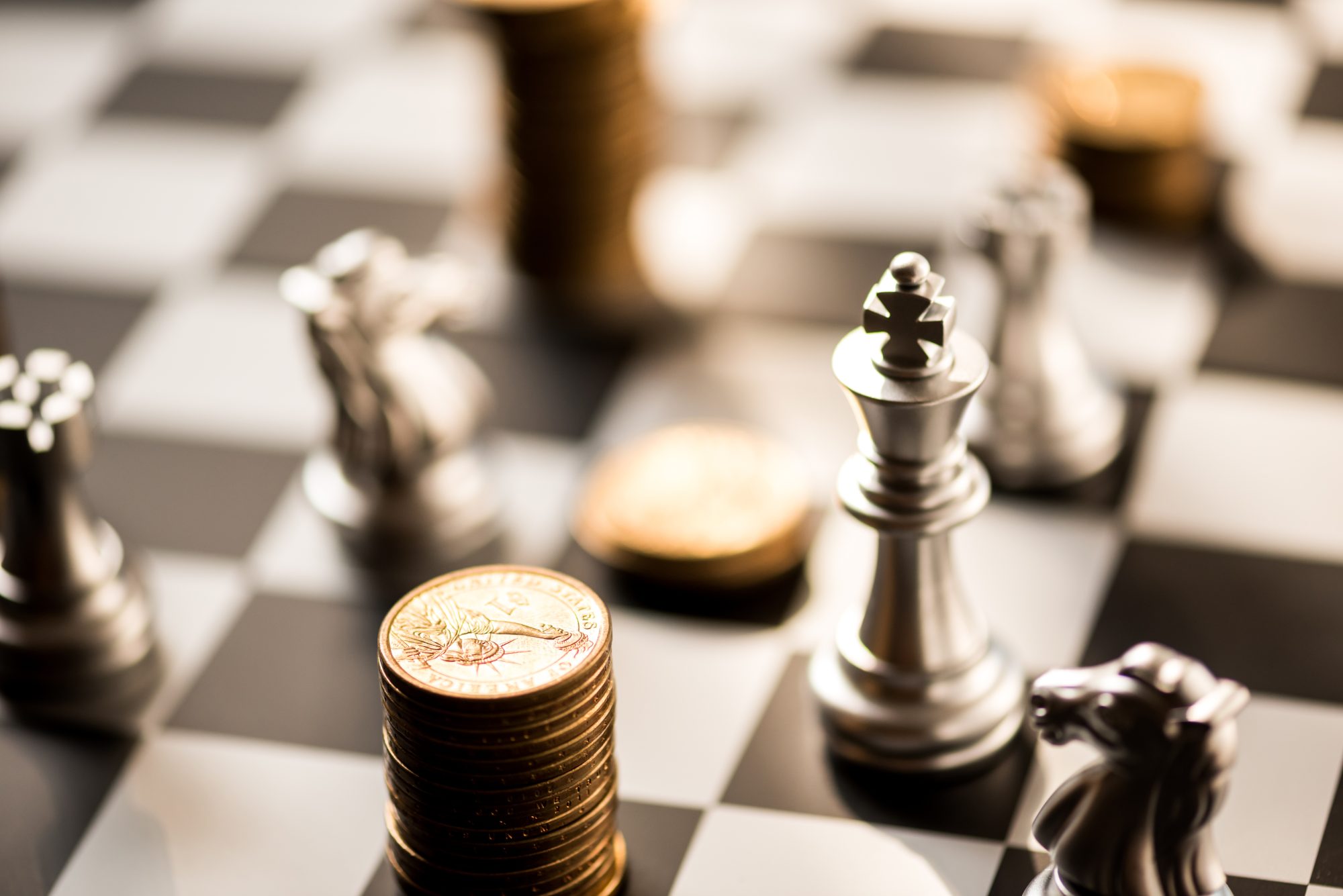 Close-Up Of Coins And Chess Pieces On Board